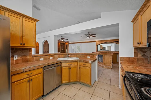 a kitchen with stainless steel appliances granite countertop a sink and cabinets