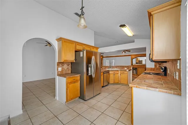 a kitchen with a refrigerator and microwave