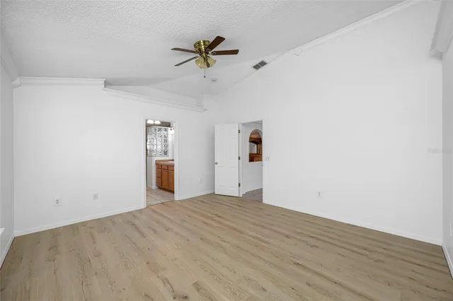 a view of empty room with wooden floor