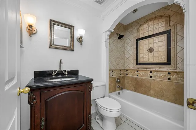 a bathroom with a granite countertop toilet a sink and bathtub