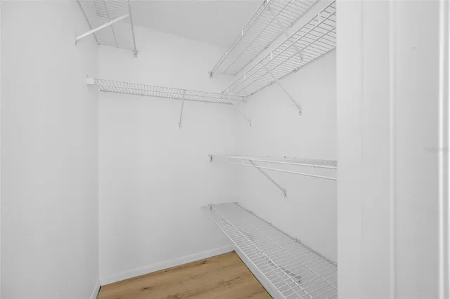 a view of walk in closet with empty racks