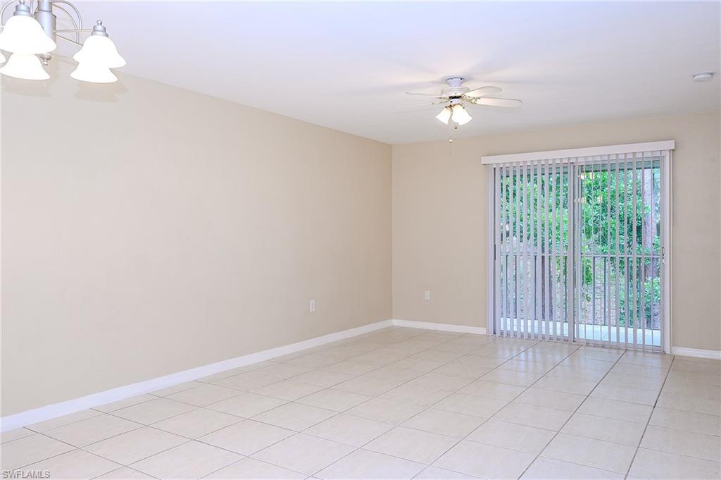 2370 Naples Trace Circle, Unit 7 Naples, FL 34109 - Photo 11 of 23 a view of an empty room with a window