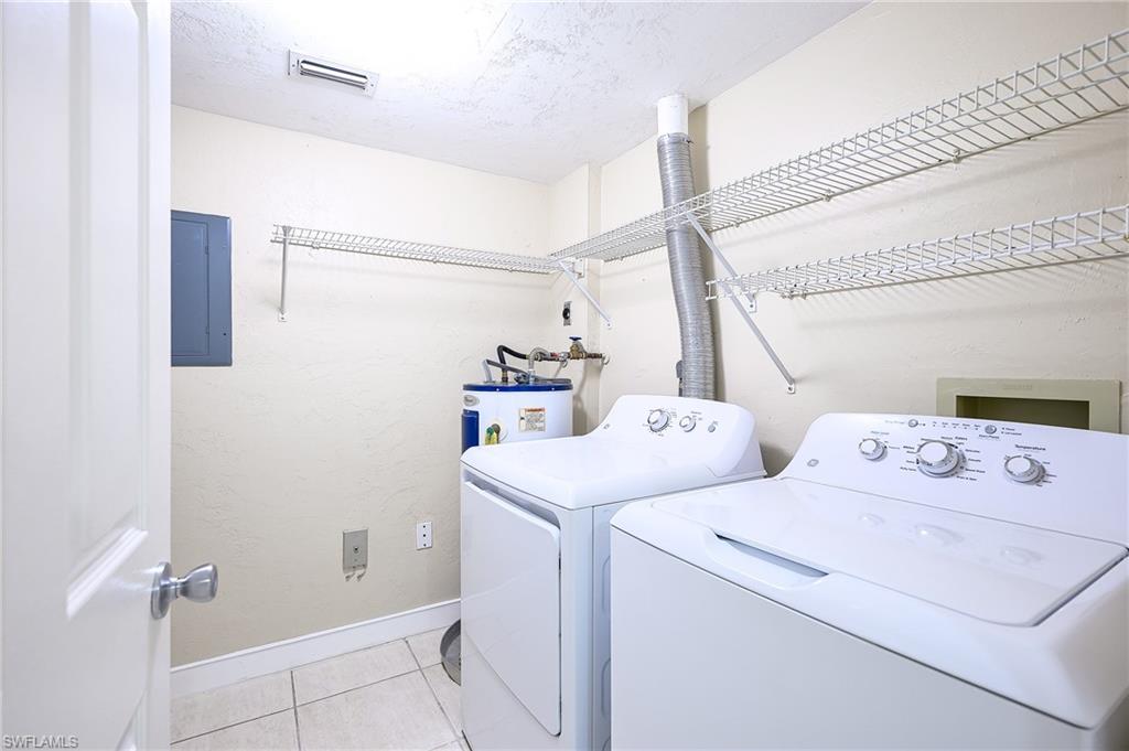 2370 Naples Trace Circle, Unit 7 Naples, FL 34109 - Photo 12 of 23 a utility room with dryer and washer