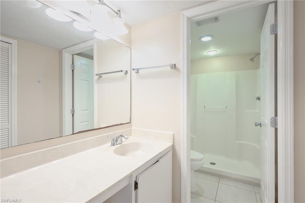 2370 Naples Trace Circle, Unit 7 Naples, FL 34109 - Photo 15 of 23 a bathroom with a sink and a shower