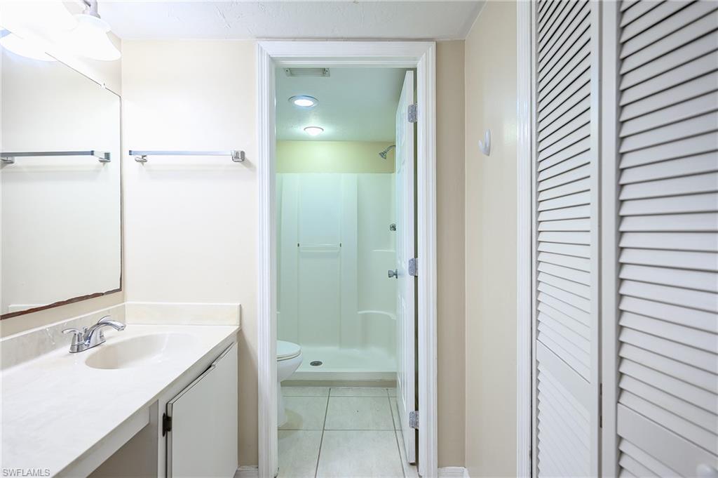 2370 Naples Trace Circle, Unit 7 Naples, FL 34109 - Photo 16 of 23 a bathroom with a sink and a mirror