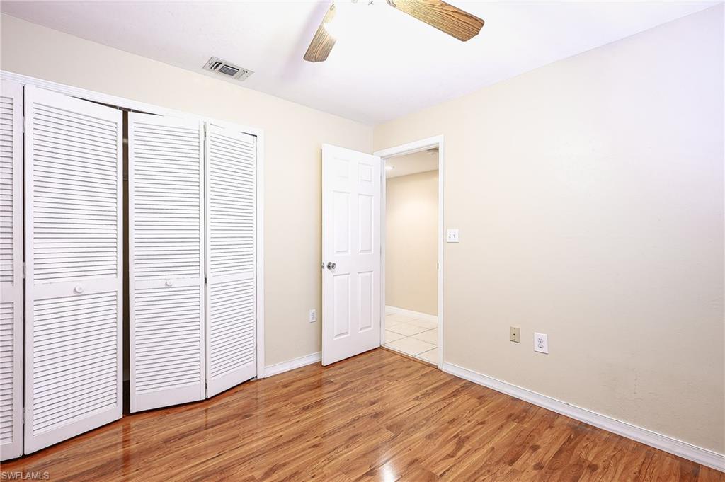 2370 Naples Trace Circle, Unit 7 Naples, FL 34109 - Photo 18 of 23 a view of an empty room with wooden floor