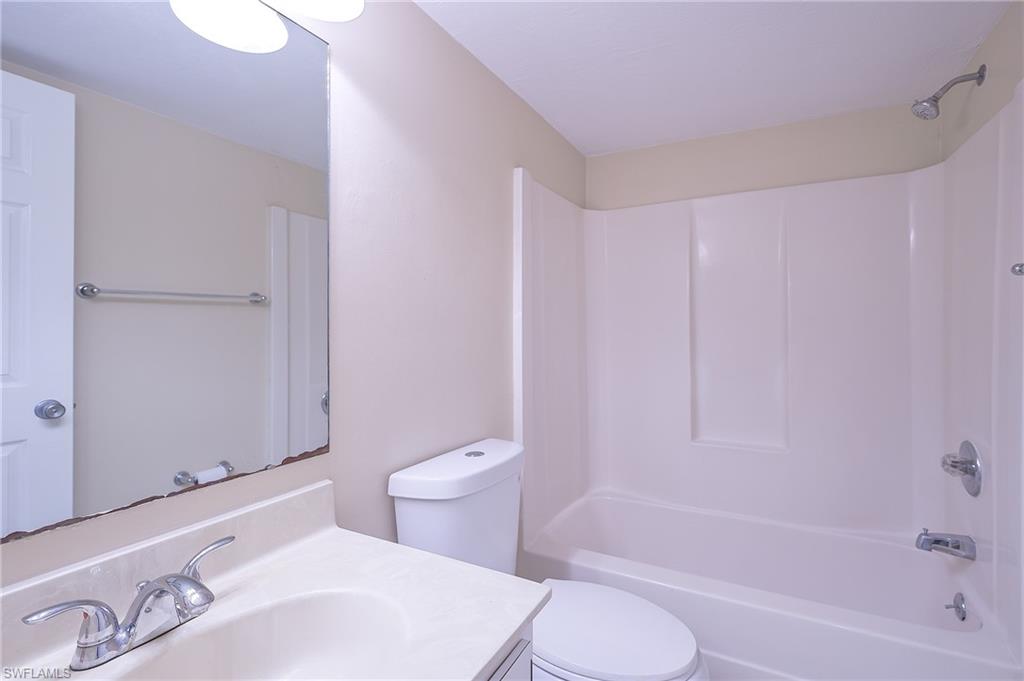 2370 Naples Trace Circle, Unit 7 Naples, FL 34109 - Photo 21 of 23 a bathroom with a sink a toilet and bathtub