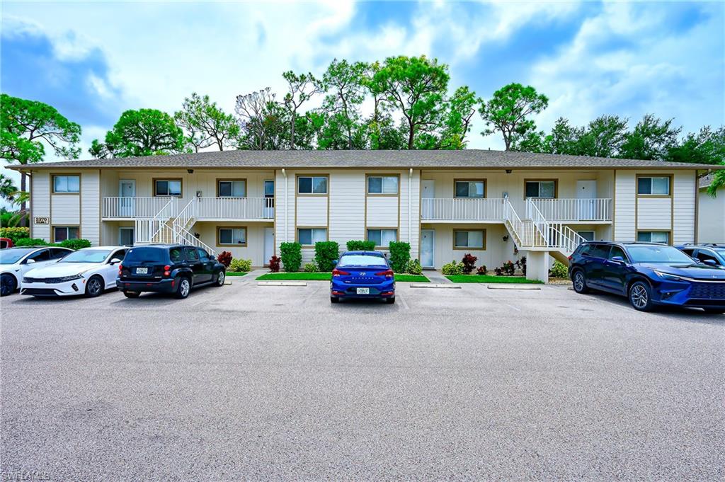 2370 Naples Trace Circle, Unit 7 Naples, FL 34109 - Photo 3 of 23 a view of a cars parked in front of a house
