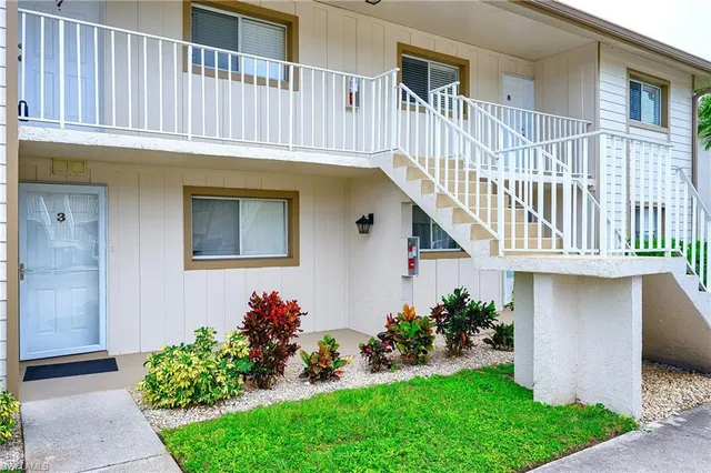 a kitchen that has a sink cabinets and a refrigerator