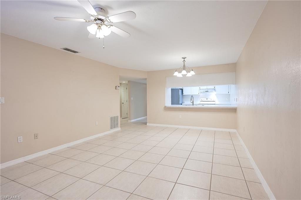 2370 Naples Trace Circle, Unit 7 Naples, FL 34109 - Photo 9 of 23 a view of an empty room and chandelier fan