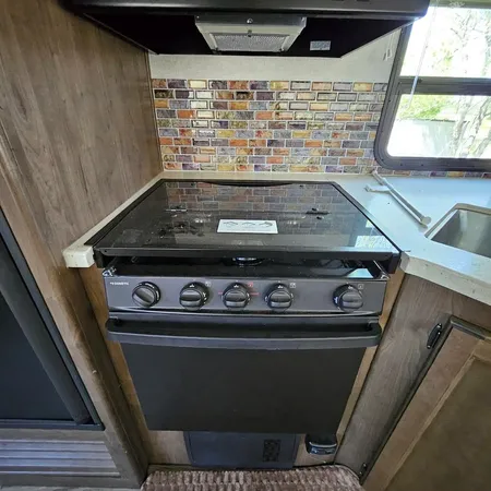 a kitchen with a sink appliances and a counter top