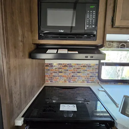 a kitchen with sink refrigerator and wooden floor