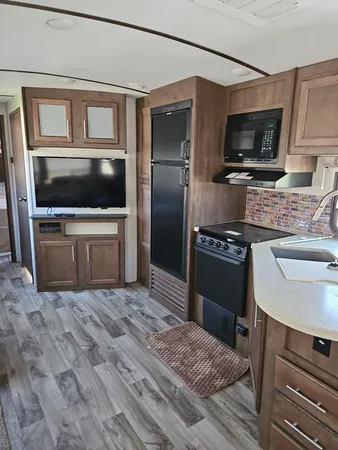 a kitchen view with a sink stainless steel appliances and cabinets