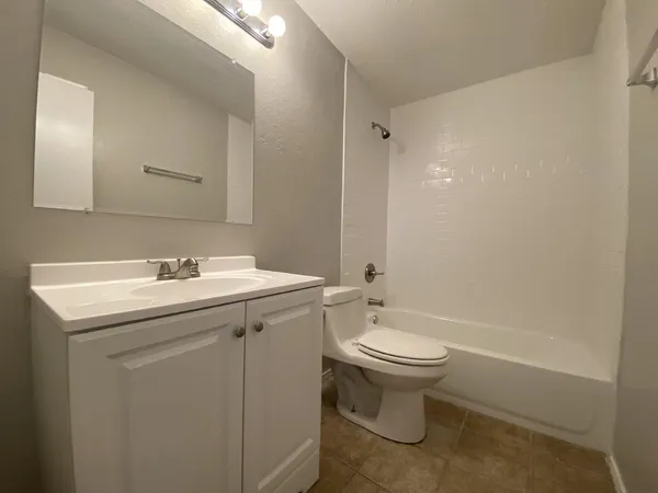 a bathroom with a sink toilet and a mirror