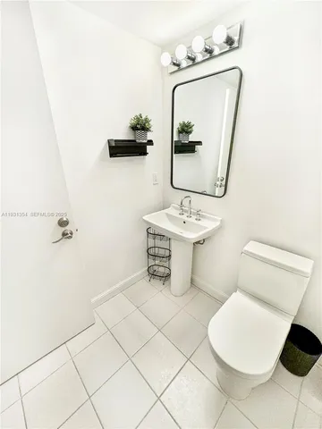 a bathroom with a toilet a sink and mirror