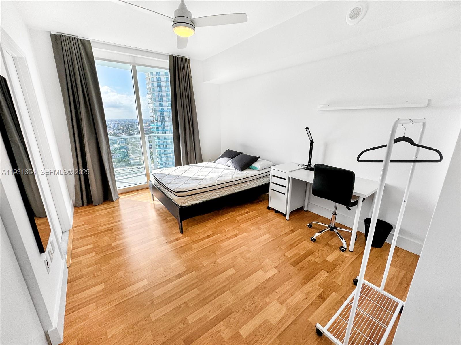 185 Southwest 7th Street, Unit 2701 Miami, FL 33130 - Photo 18 of 24 a living room with furniture and a window