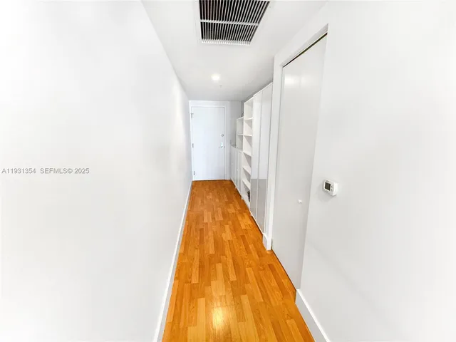 a view of a hallway with stairs
