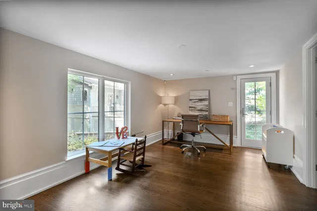 a bathroom with a toilet a sink a mirror and shower