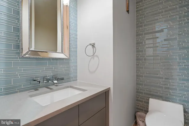 a living room with furniture a window and wooden floor