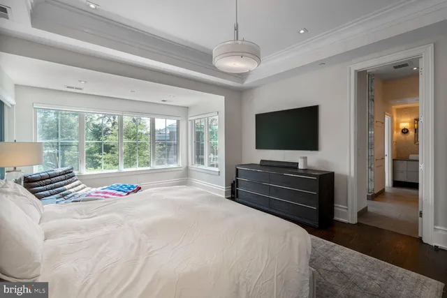 a bedroom with a large bed and a large window