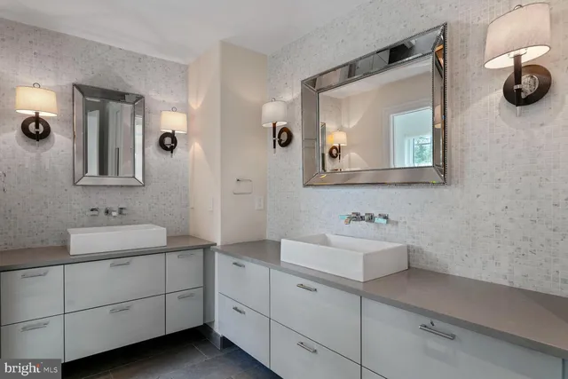 a bathroom with a double vanity sink a mirror and a shower