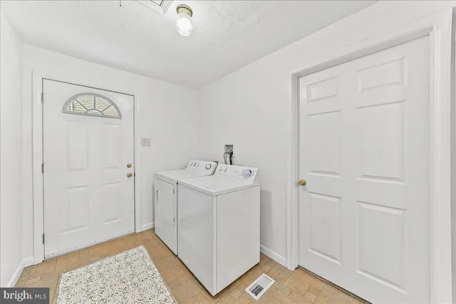 a utility room with a sink dryer and washer