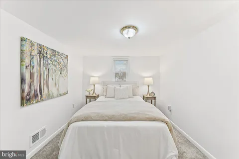 a bedroom with a bed and a night stand