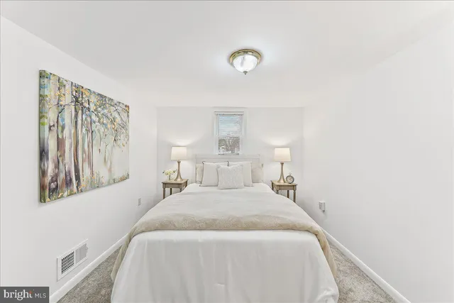 a bedroom with a bed and a night stand