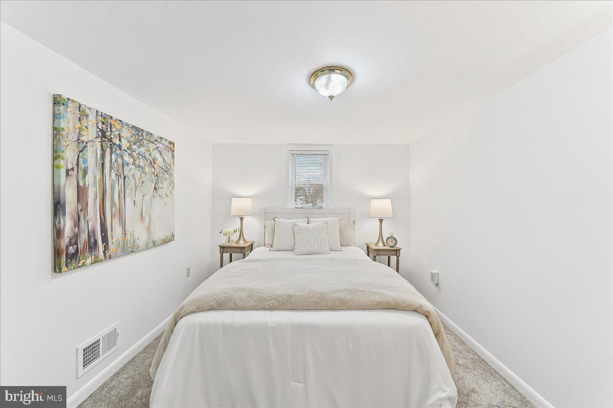 929 Crystle Road Aston, PA 19014 - Photo 14 of 18 a bedroom with a bed and a night stand