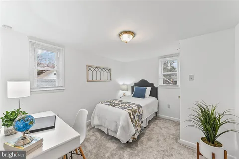 a bedroom with a bed and a couch