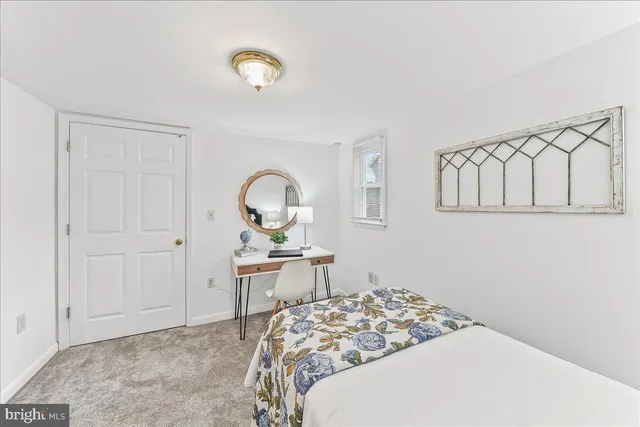 a bedroom with a bed and a table in it