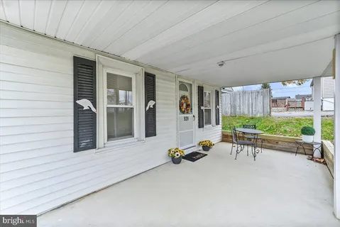 a balcony with furniture and a gate