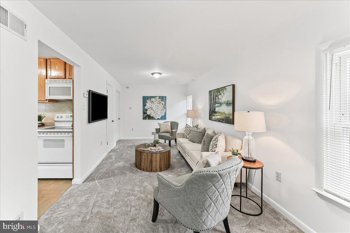 929 Crystle Road Aston, PA 19014 - Photo 6 of 18 a living room with furniture a flat screen tv and a window