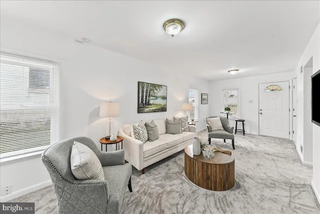 a living room with furniture a rug and a window