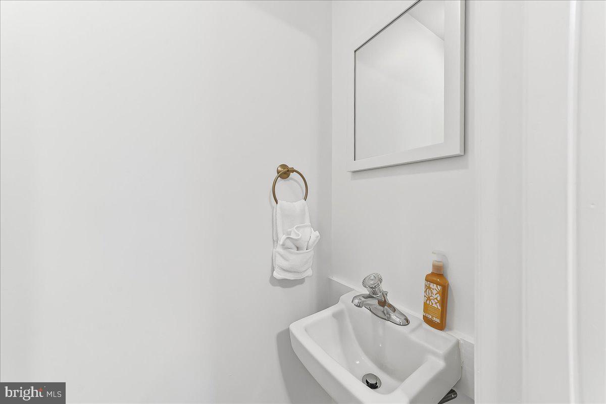 929 Crystle Road Aston, PA 19014 - Photo 8 of 18 a bathroom with a sink and mirror