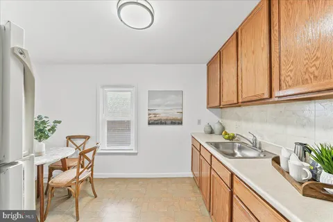 a view of a kitchen area with furniture and wooden floor