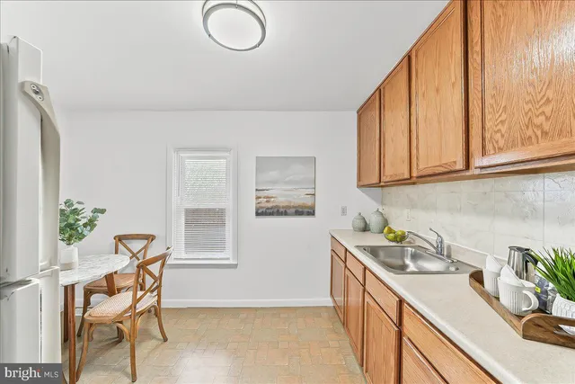 a view of a kitchen area with furniture and wooden floor