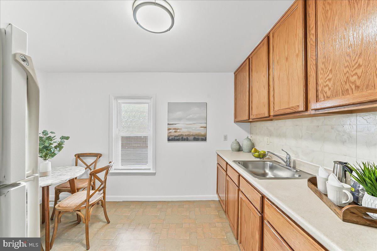929 Crystle Road Aston, PA 19014 - Photo 10 of 18 a view of a kitchen area with furniture and wooden floor