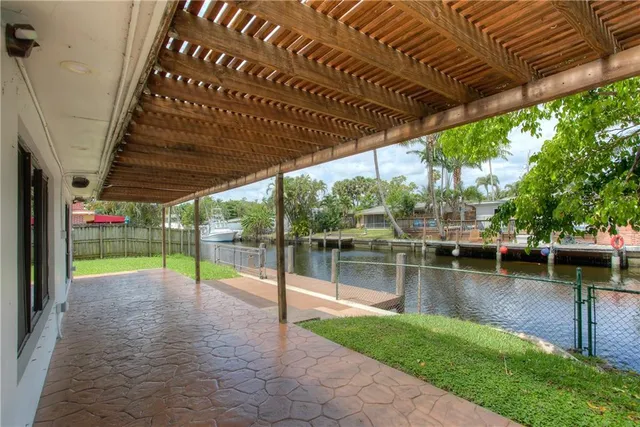 a view of a backyard with swimming pool