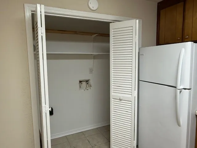 a white refrigerator freezer and a dishwasher sitting in a kitchen