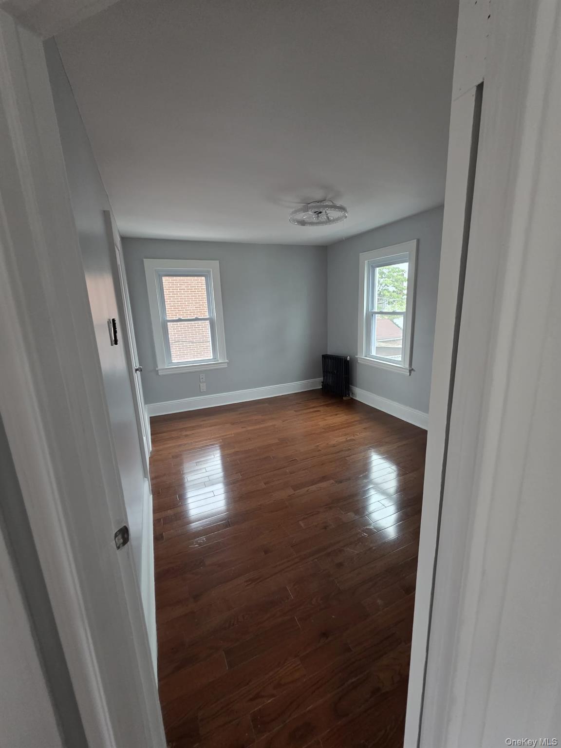 109-73 200th Street Queens, NY 11412 - Photo 2 of 12 an empty room with windows