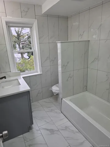 a bathroom with a sink a toilet and a bathtub