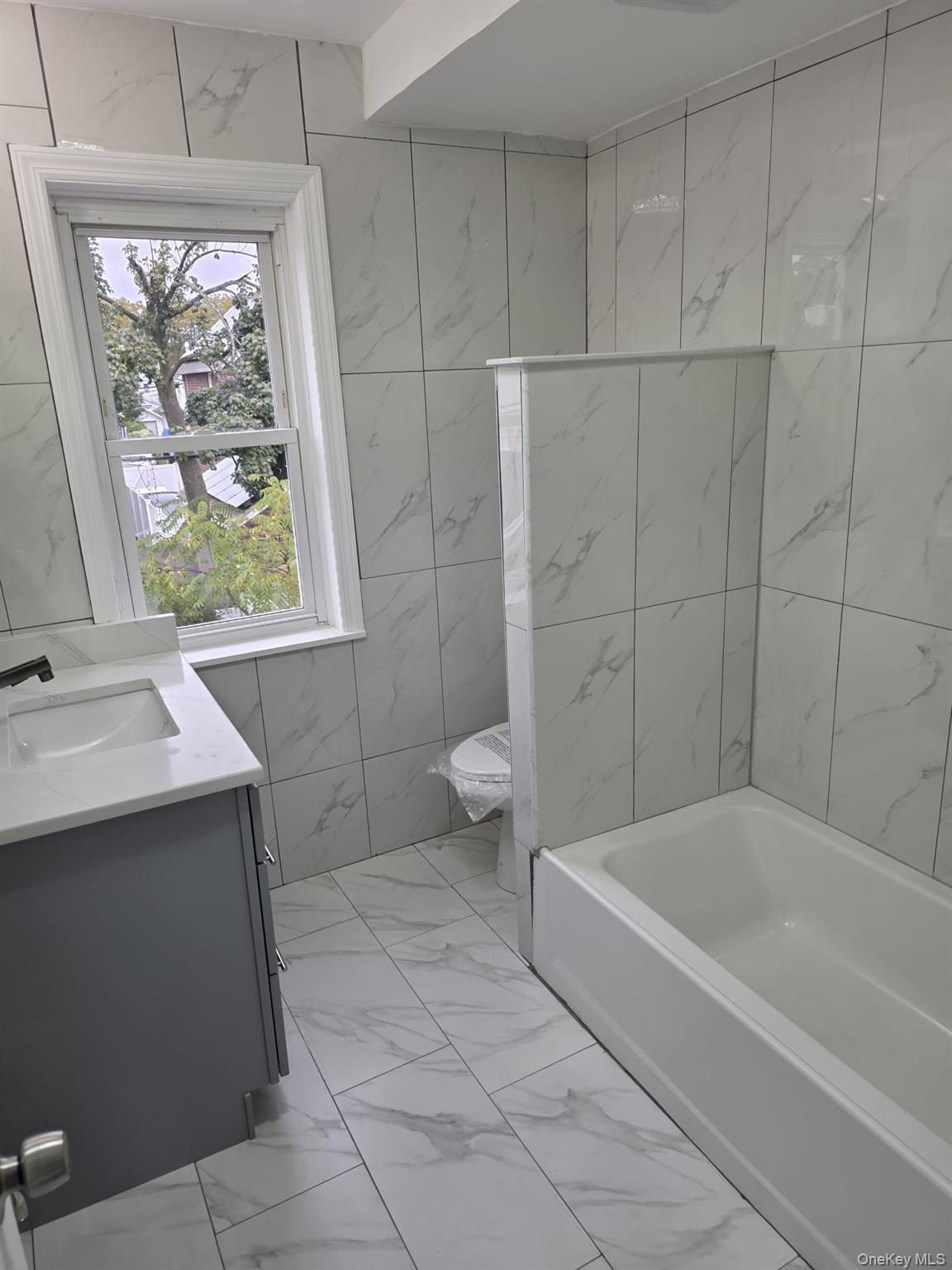 109-73 200th Street Queens, NY 11412 - Photo 3 of 12 a bathroom with a sink a toilet and a bathtub