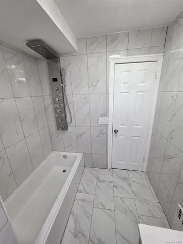 a bathroom with a bathtub and shower