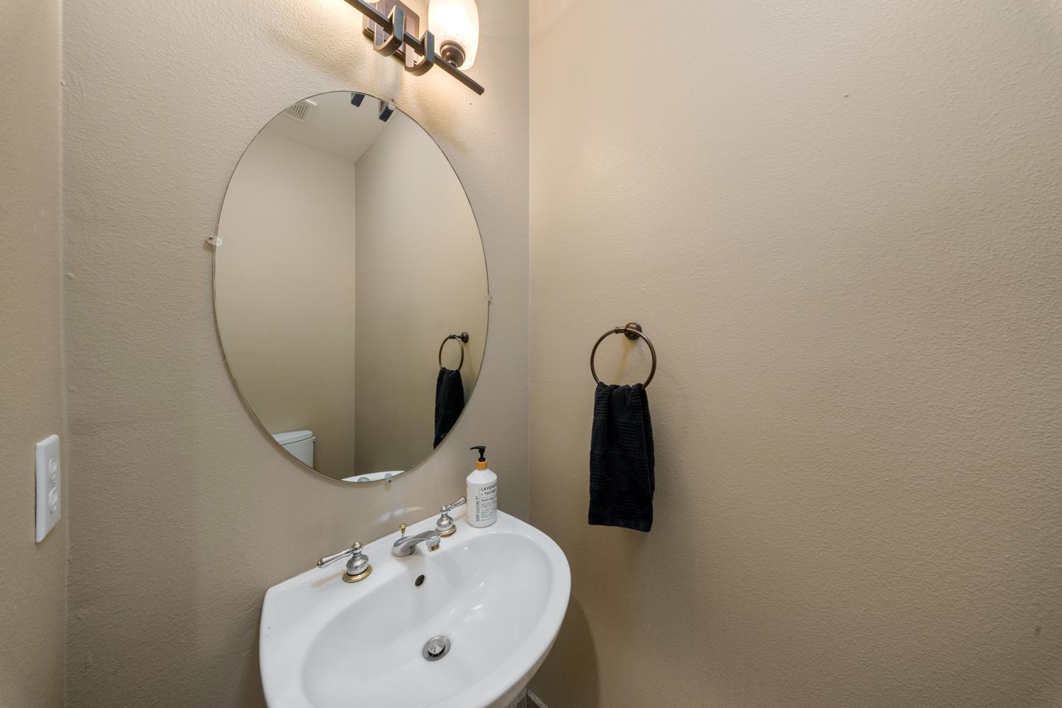 4601 Vía Altura Modesto, CA 95357 - Photo 21 of 30 a bathroom with a sink and mirror