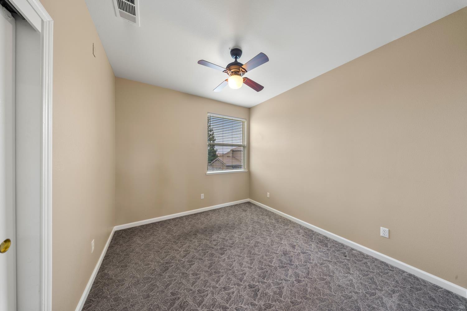 4601 Vía Altura Modesto, CA 95357 - Photo 23 of 30 an empty room with a window and a ceiling fan
