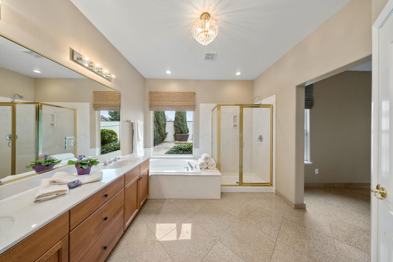 4601 Vía Altura Modesto, CA 95357 - Photo 4 of 30 a spacious bathroom with a double vanity sink a large mirror and a bathtub