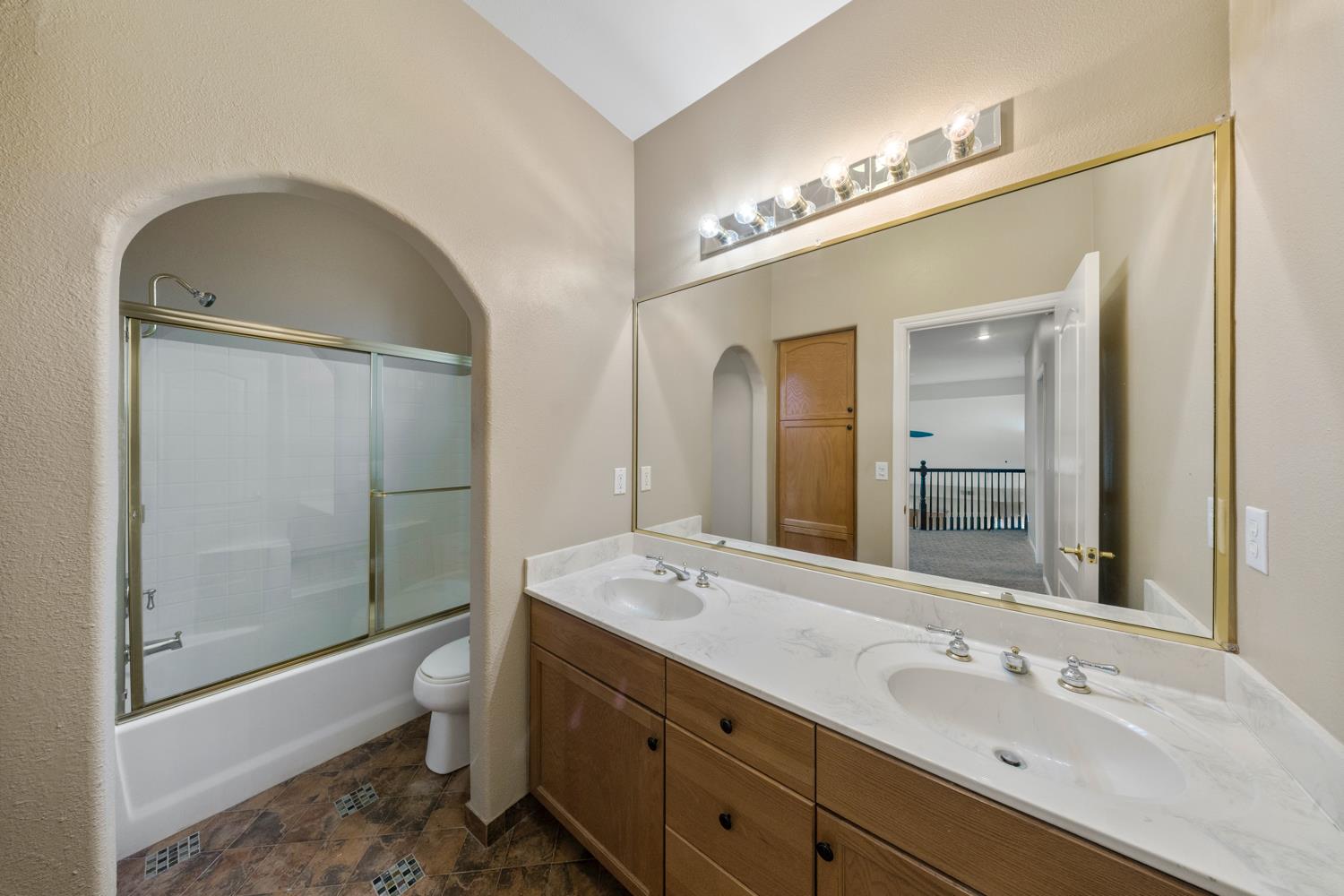4601 Vía Altura Modesto, CA 95357 - Photo 6 of 30 a bathroom with a double vanity sink a toilet and shower