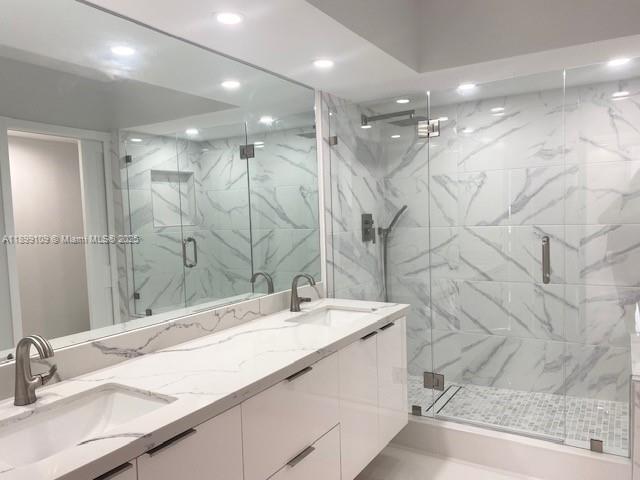 3530 Mystic Pointe Drive, Unit 2503 Aventura, FL 33180 - Photo 13 of 24 a bathroom with a double vanity sink mirror and shower