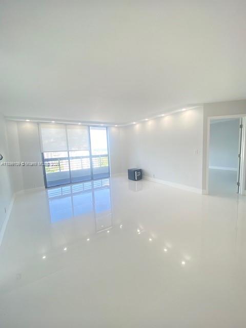 3530 Mystic Pointe Drive, Unit 2503 Aventura, FL 33180 - Photo 17 of 24 a view of an empty room with a window